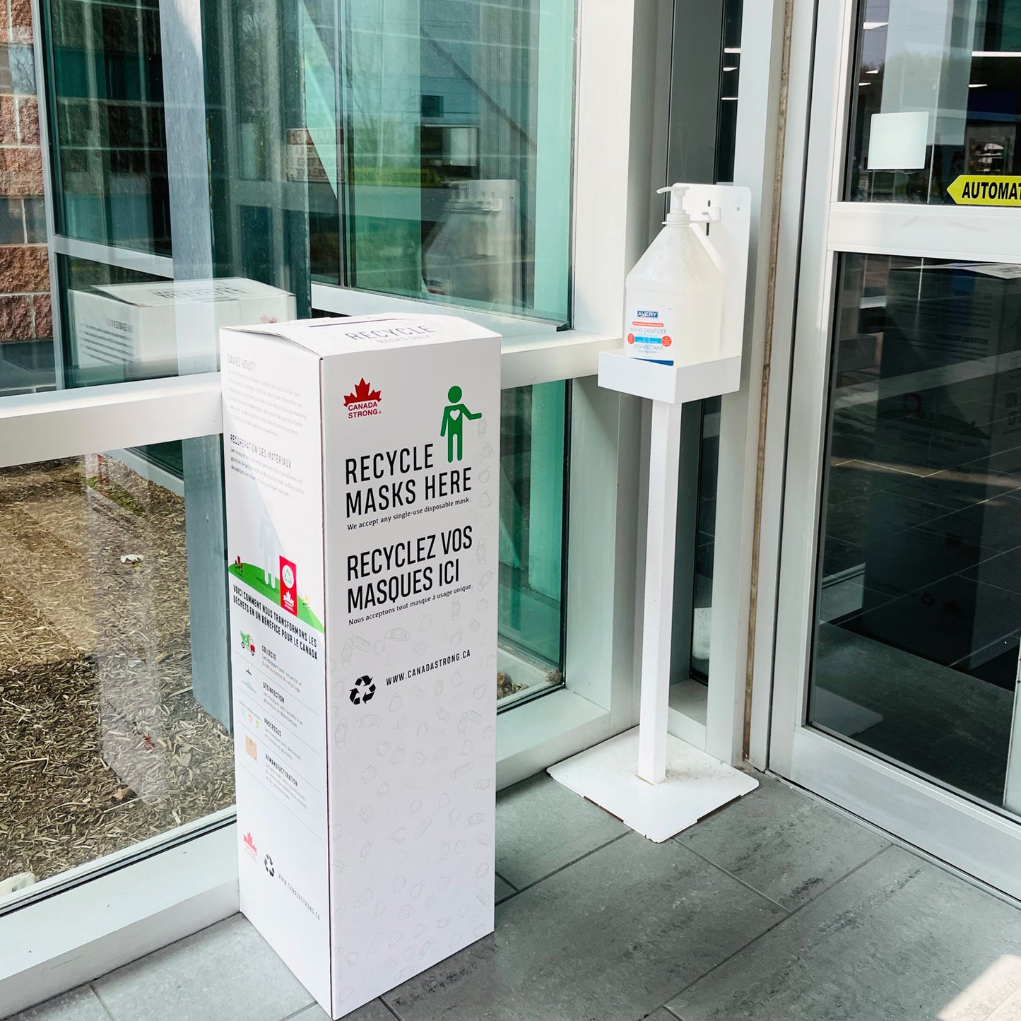 Face mask recycling box in a lobby reception entrance area of a business or dental clinic.