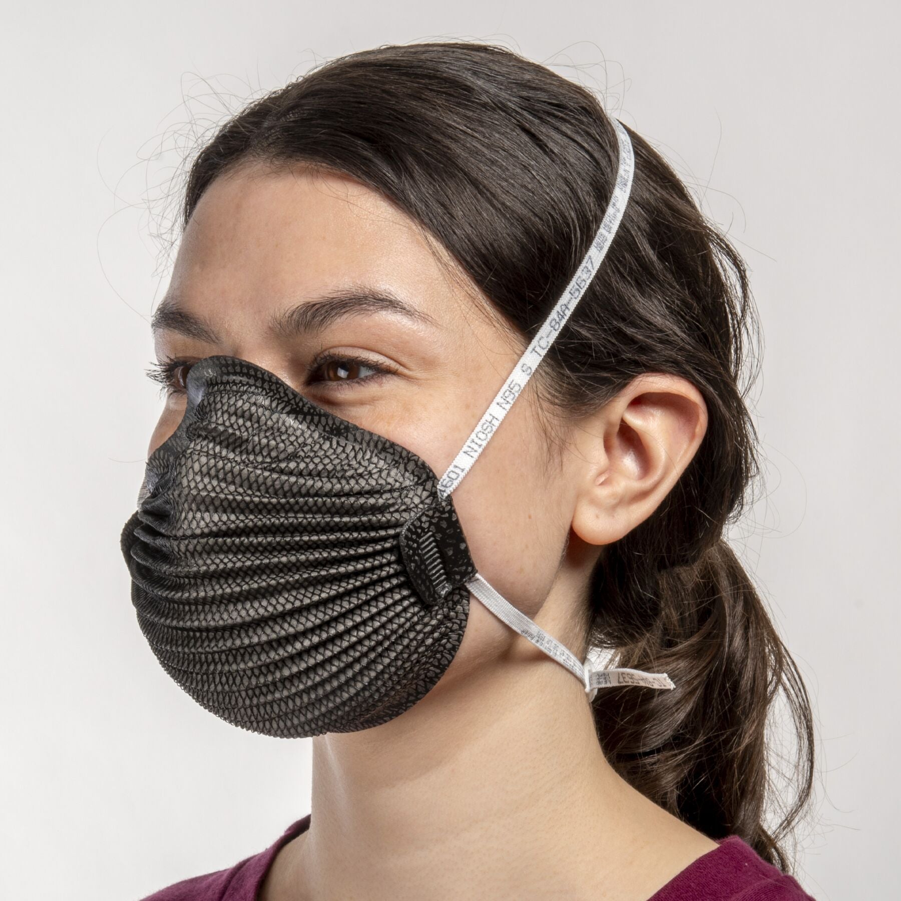 Woman wearing small black NIOSH N95 Airwave M4601 respirator mask from Canada Strong Masks.