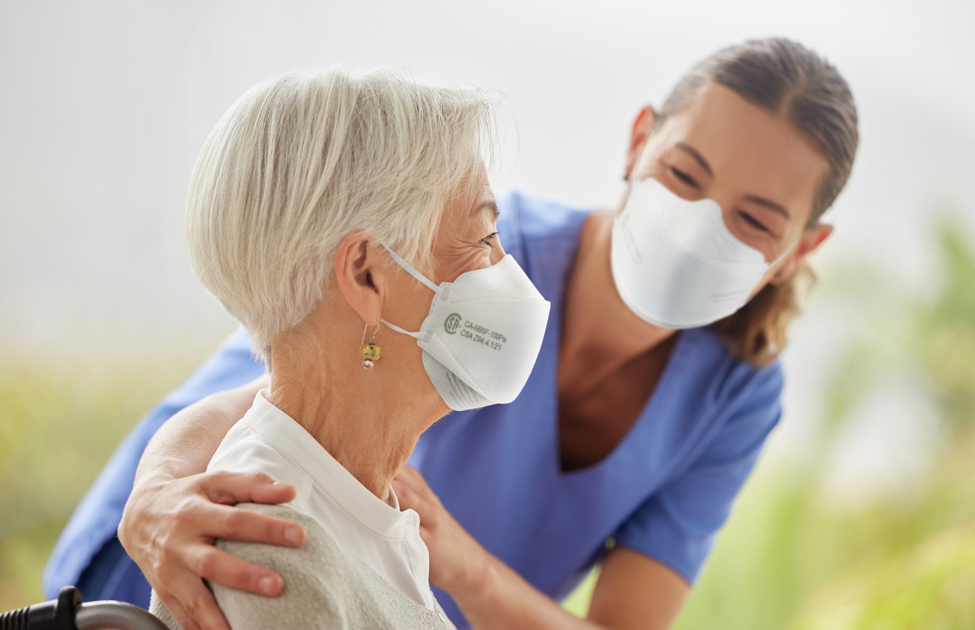Health care worker nurse and patient wearing Canada Masq Q100 CSA respirator face mask