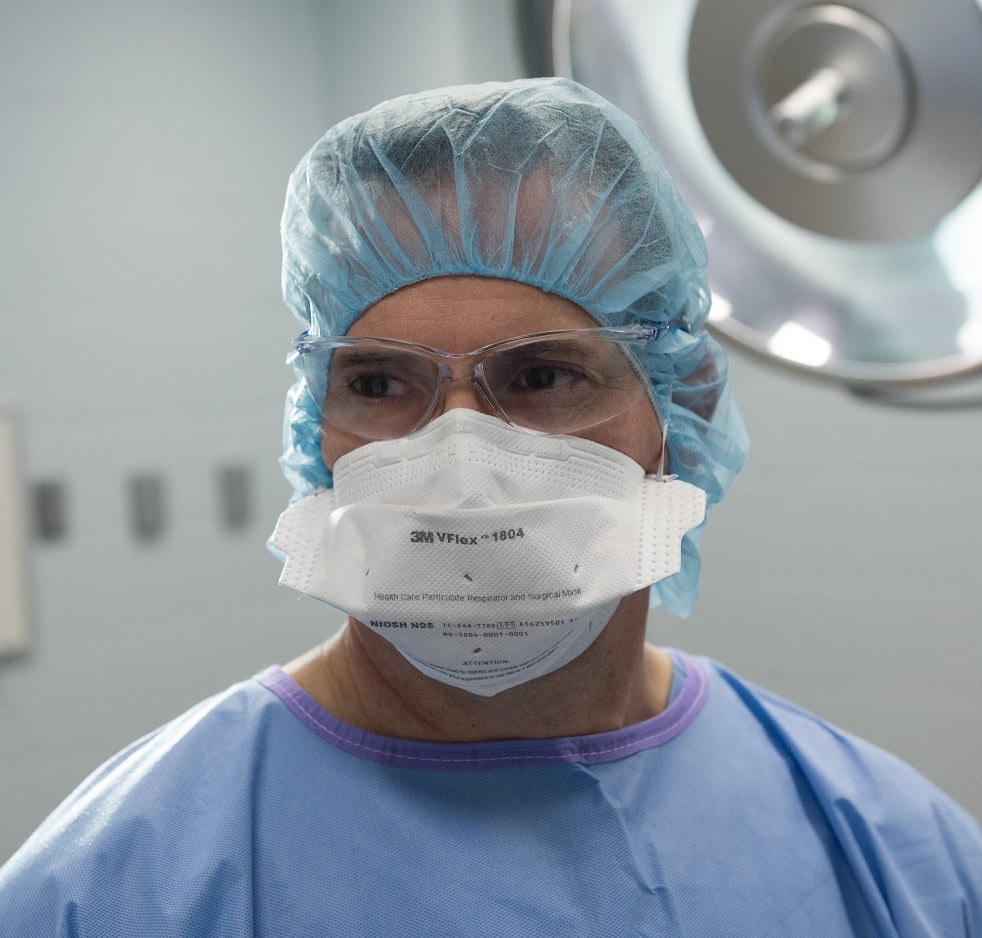 healthcare man wearing 3M Canada 1804 surgical respirator mask N95 in hospital operating room