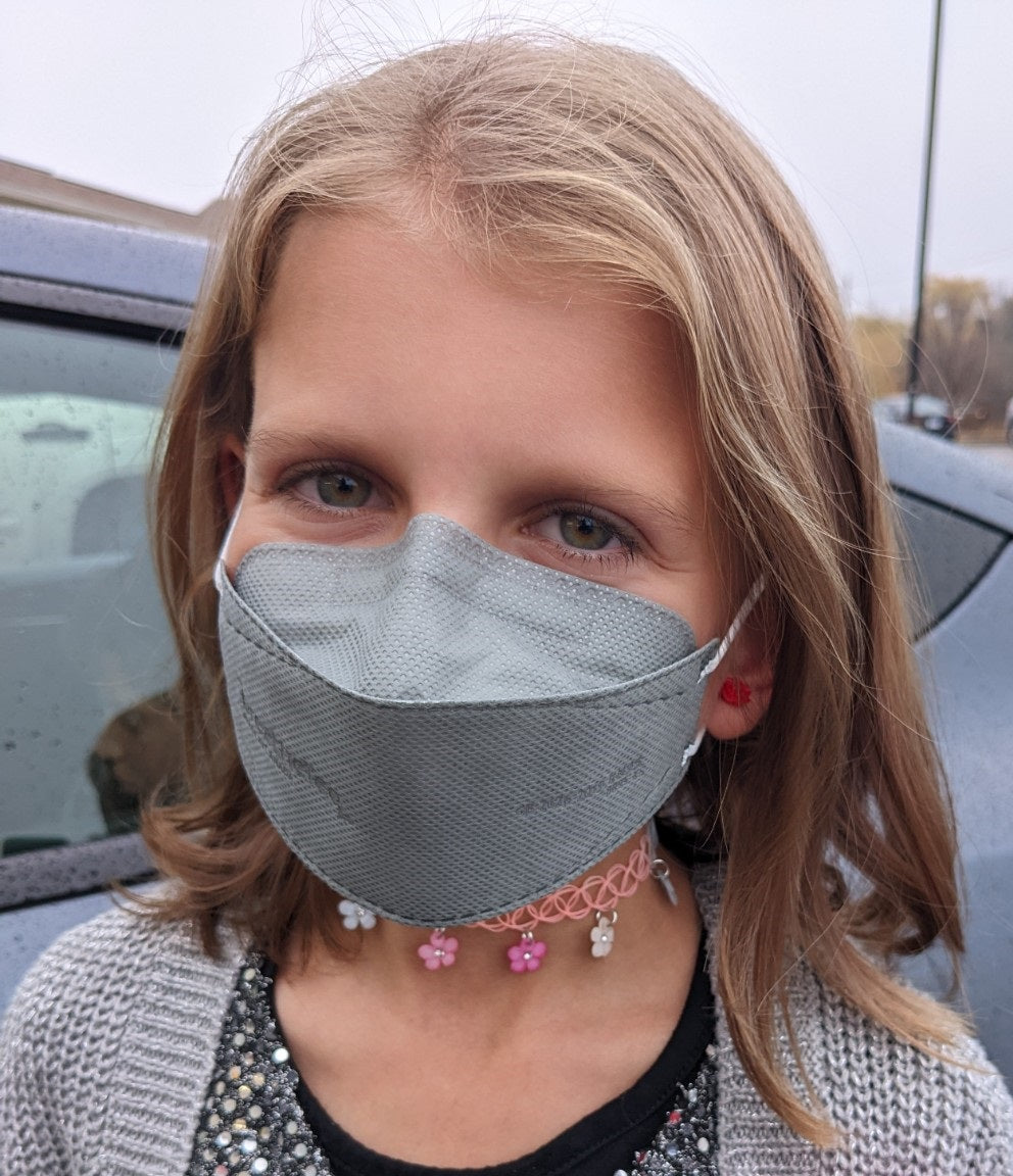 Young girl wearing grey KN95 breathetech Canadian respirator face mask for school in Canada