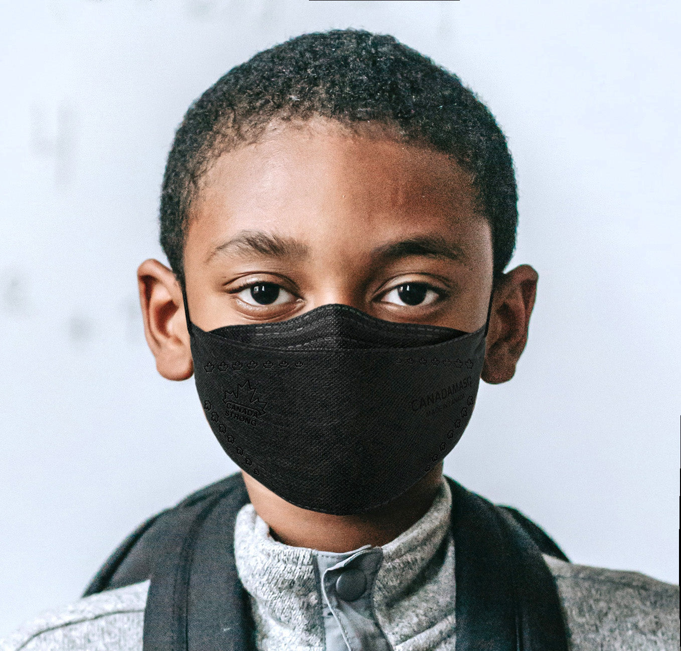 boy wearing black CA-N95 mask